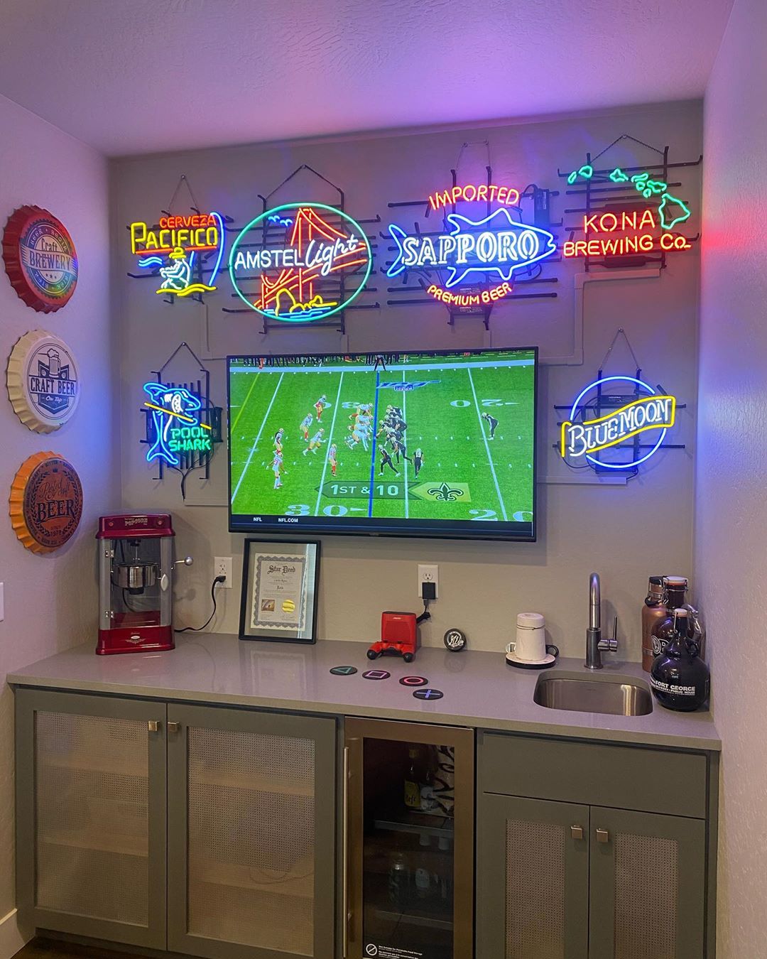 Basement Bar Area with TV and Neon Signs on the Wall. Photo by Instagram user @the.carto.grapher