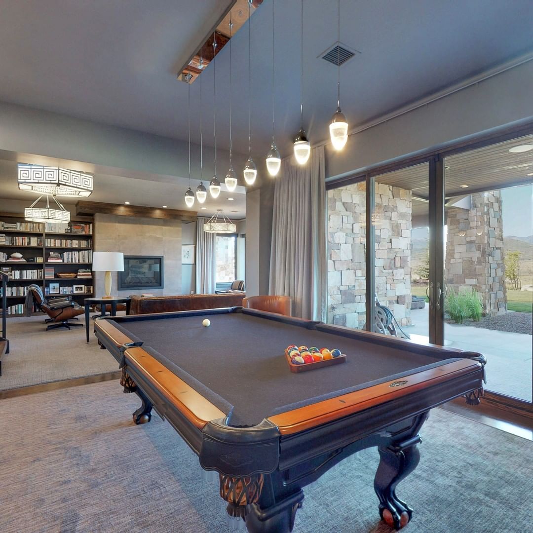 Basement Hangout Space with Pool Table and Nice Lighting Above. Photo by Instagram user @highlandcustomhomes