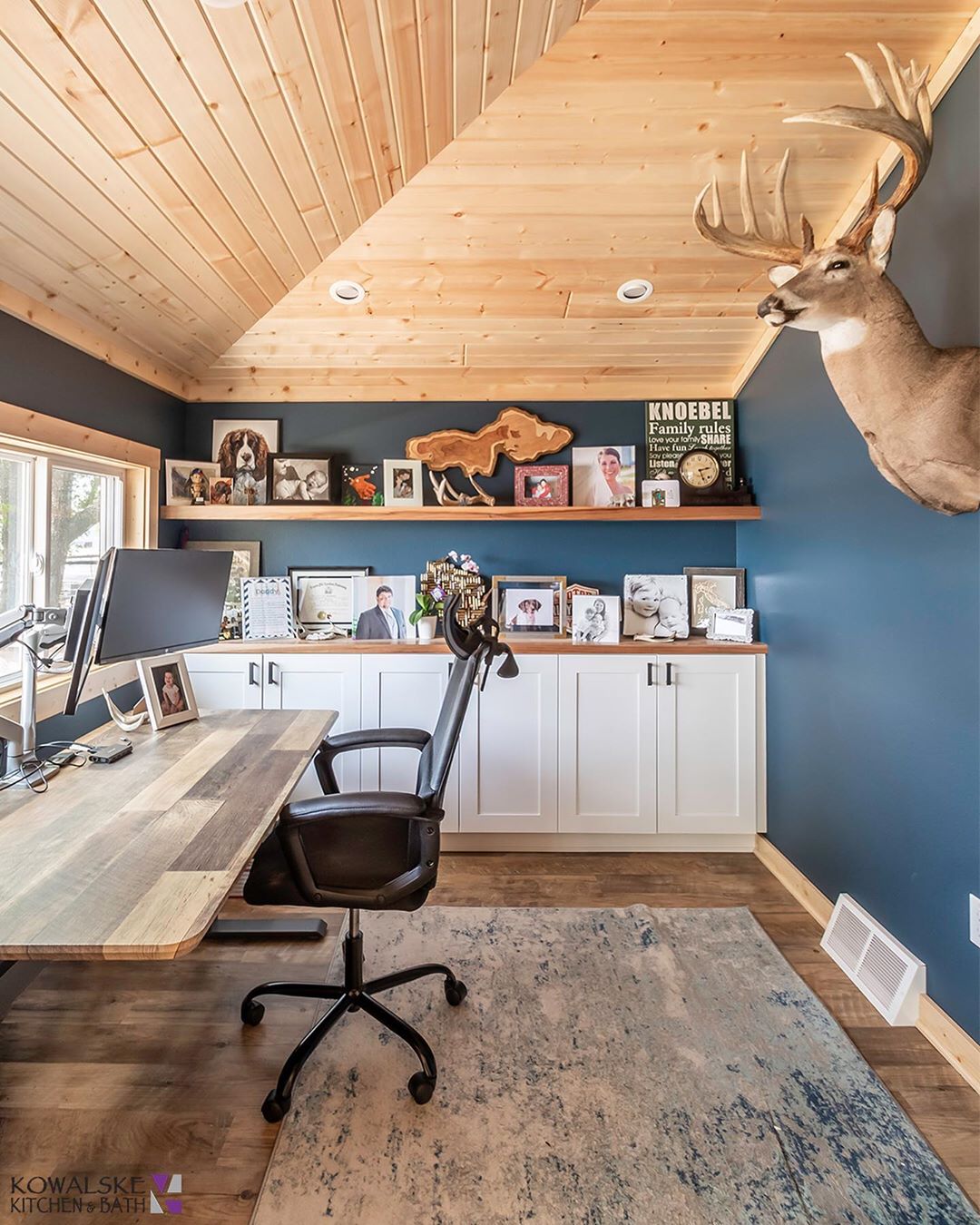 Classic Home Office with Large Reclaimed Wood Desk and Deer Head on the Wall. Photo by Instagram user @kowalskekitchenandbath
