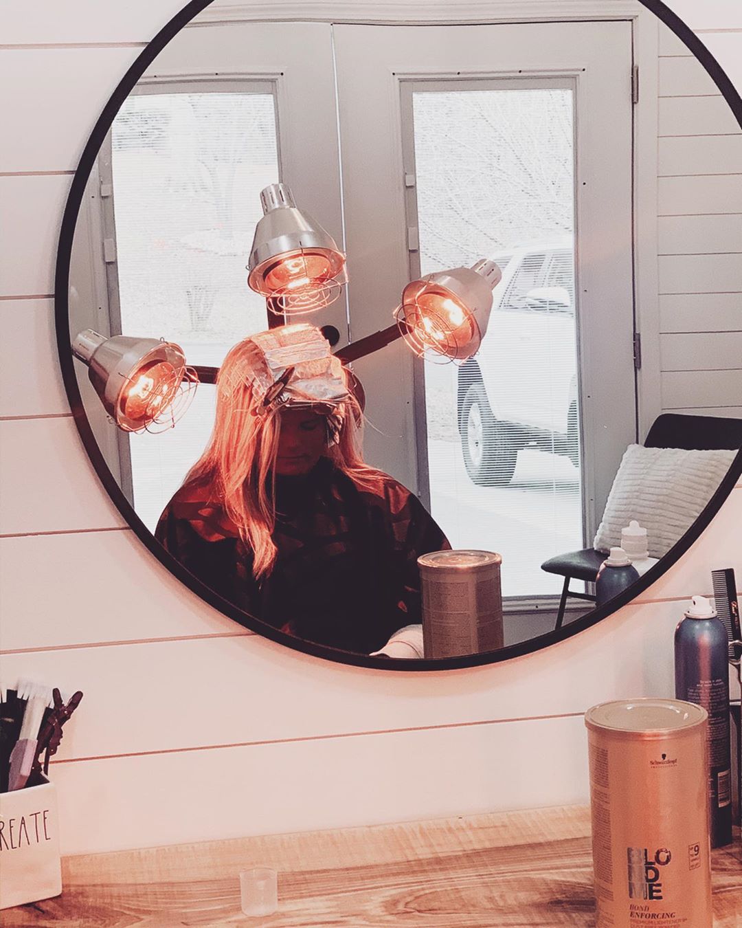 Woman Sitting Under Heat Lamps at a Hair Salon. Photo by Instagram user @chelseaschairforhair