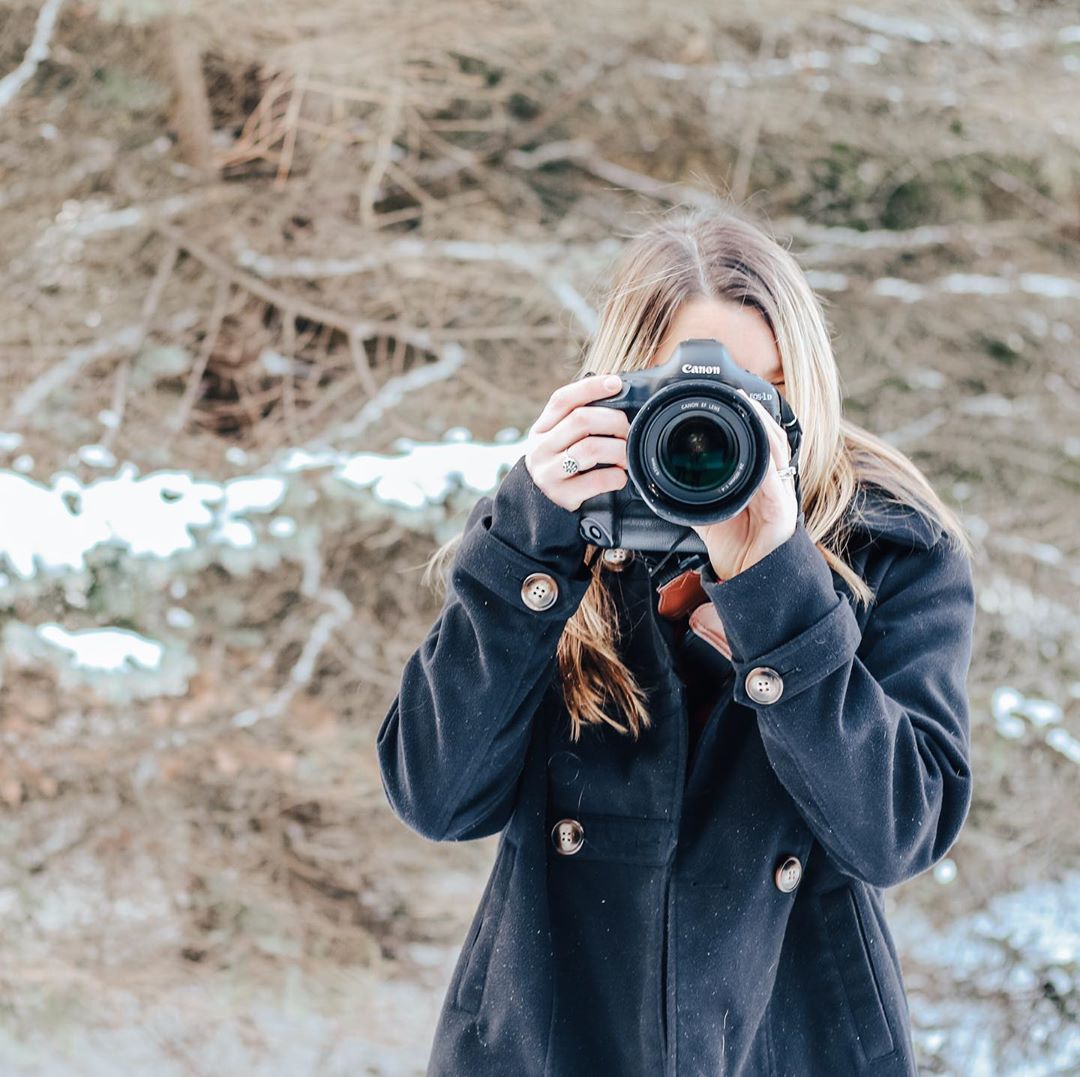 Woman Taking a Photo of Someone in Winter. Photo by Instagram user @alexglewisphotography