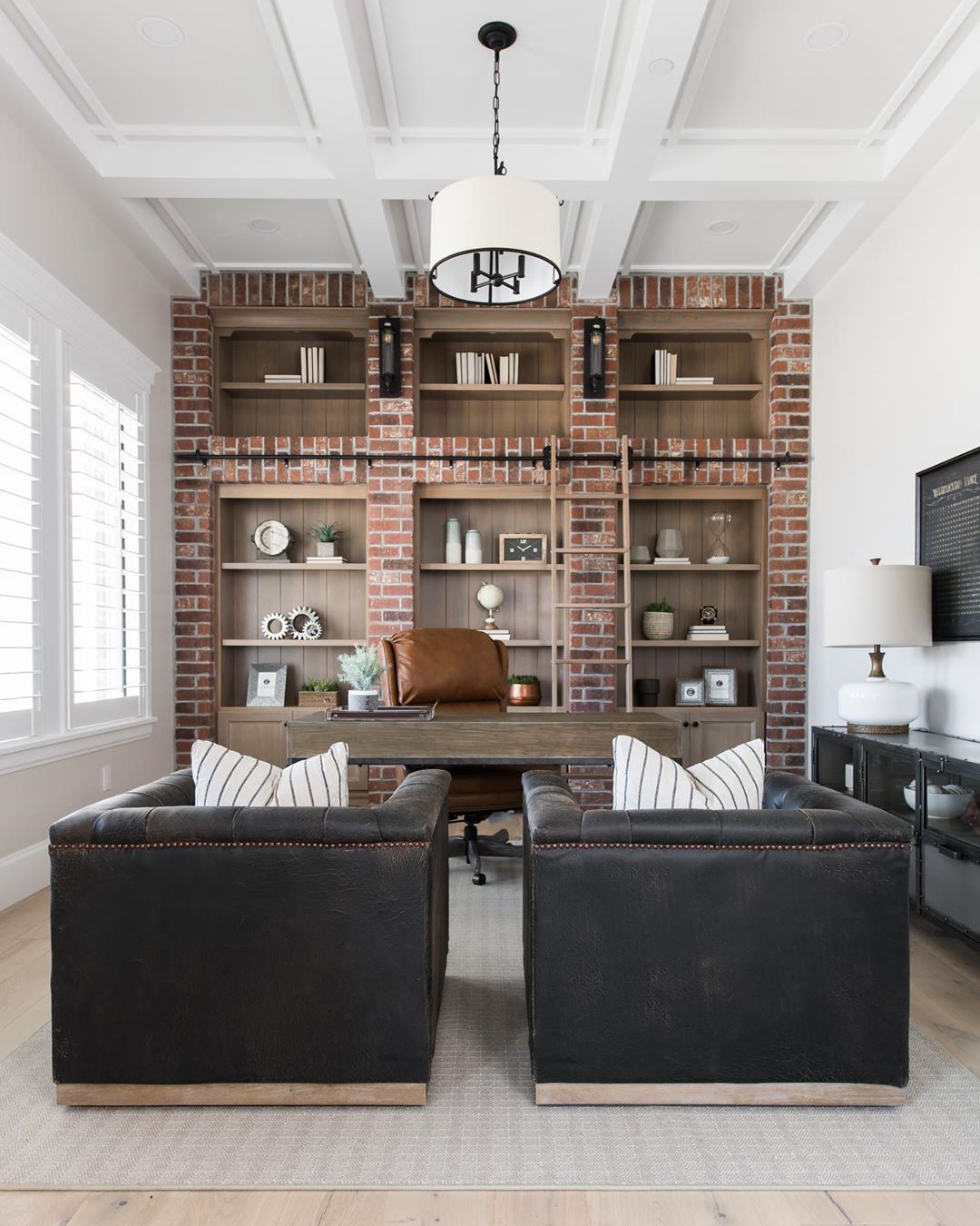 Rustic Looking Home office with Brick Wall and Leather Chairs. Photo by Instagram user @elementsstyle