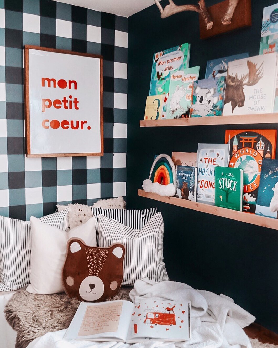 Kid Centric Reading Nook with Books Set Up on the Wall. Photo by Instagram user @tara_st.louis