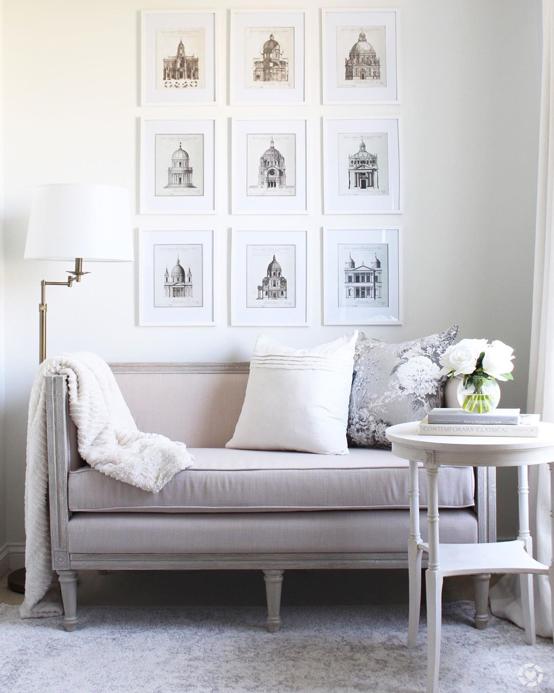 Clean Reading Space with a Gallery Wall Set Up and a Love Seat. Photo by Instagram user @tuftandtrim