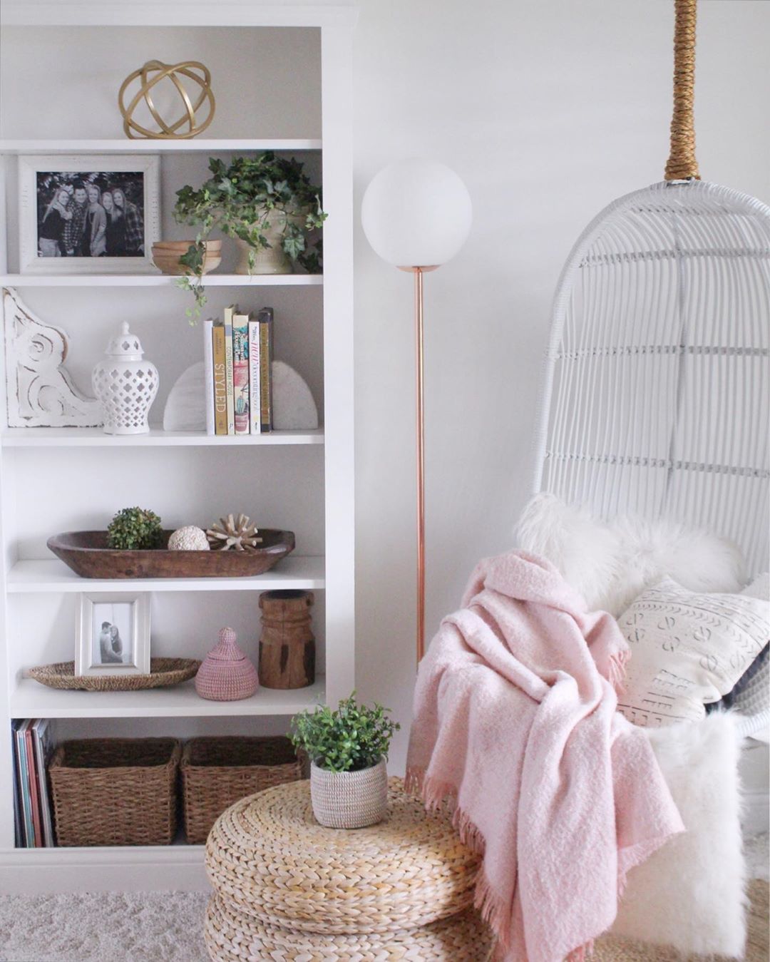Cozy Reading Nook with a Hanging Basket Chair Next to a Bookshelf. Photo by Instagram user @simplecozycharm