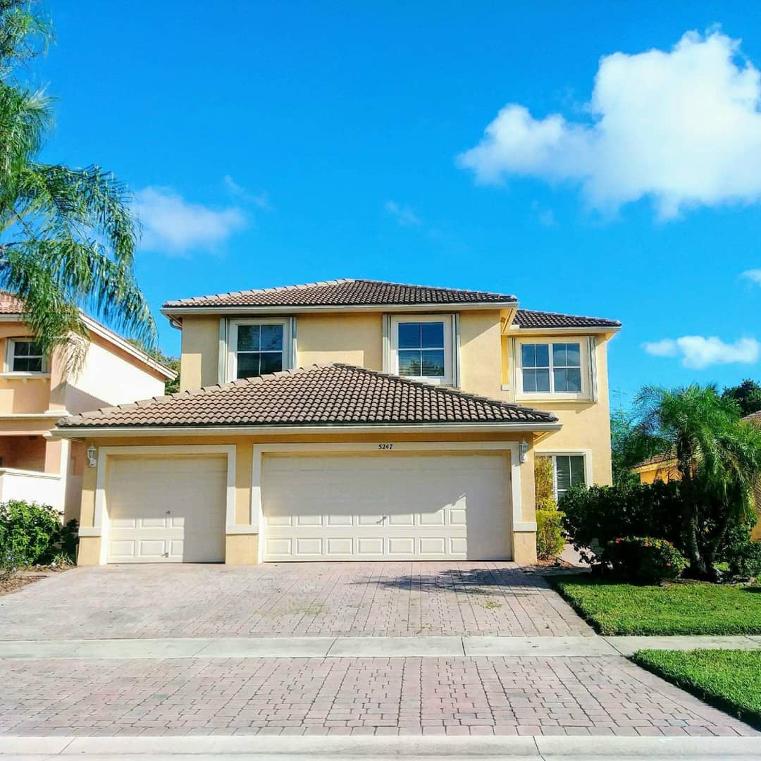 Yellow Two Story Single Family Home in Villages of West Palm Beach Lakes. Photo by Instagram user @sunshinepropertieswpb