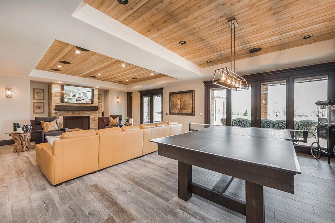 Beautifully Designed Finished Basement with Ping Pong Table and Wood Accents on the Ceiling. Photo by Instagram user @lanemyershomes