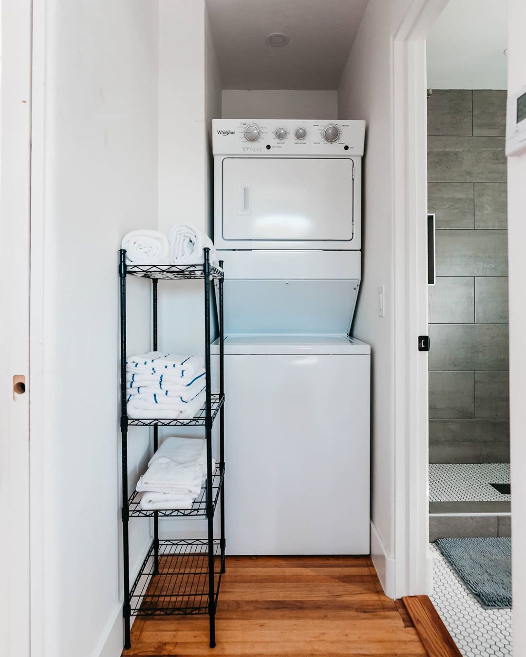 Stacked Washer and Dryer Next to Bathroom. Photo by Instagram user @thehillcresthavenairbnb