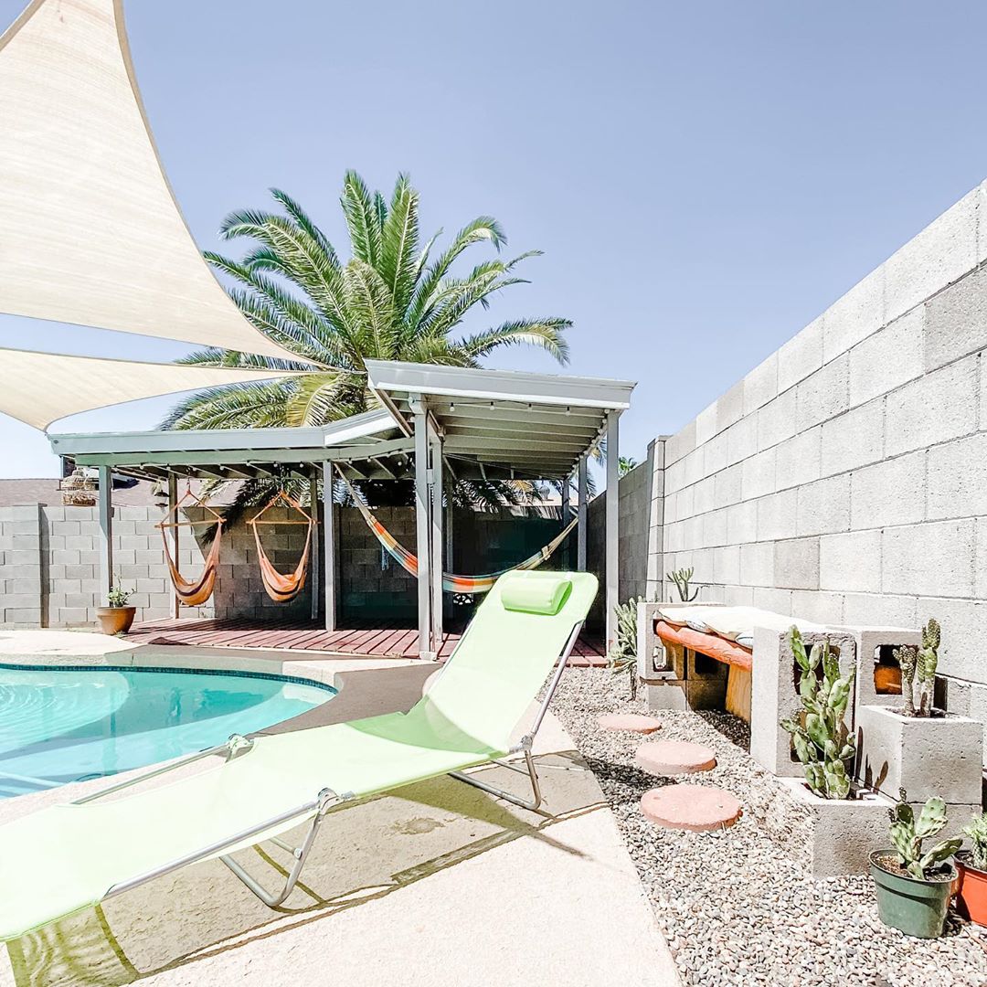 Backyard Pool with Corner Pergola, Xeriscaping, and Cloth Overhangs Providing Shade. Photo by Instagram user @pegasus_trail