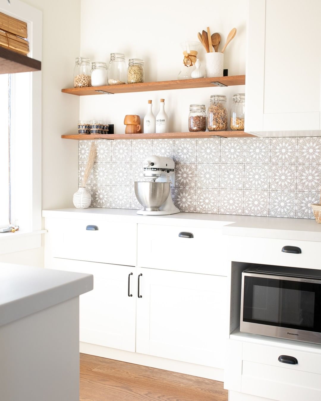 Clean White Kitchen with Minimal Items on Counter. Photo by Instagram user @amanda_holstein