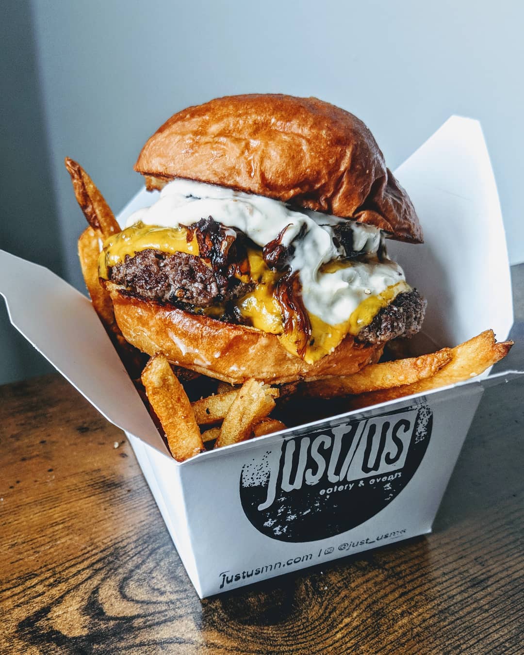 Smash Burger in a Takeout Container from Just Us in Minnesota. Photo by Instagram user @just_usmn