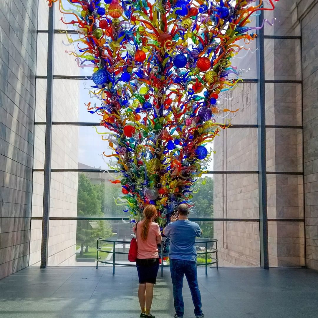 Two People Standing in Front of a Large Chihuly Sculpture at the Joslyn Art Museum. Photo by Instagram user @joslynartmuseum