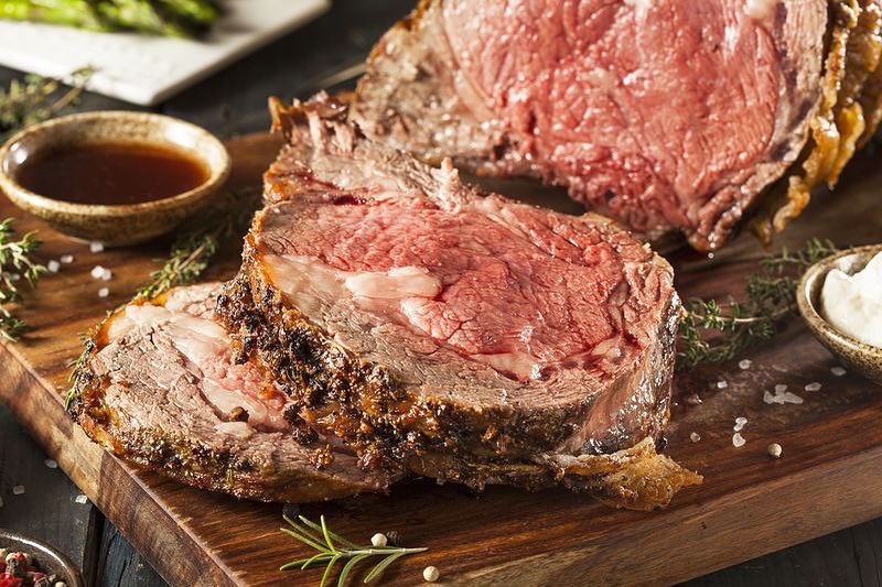 Prime Rib Cooked and Cut on a Wooden Plank. Photo by Instagram user @goratsomaha