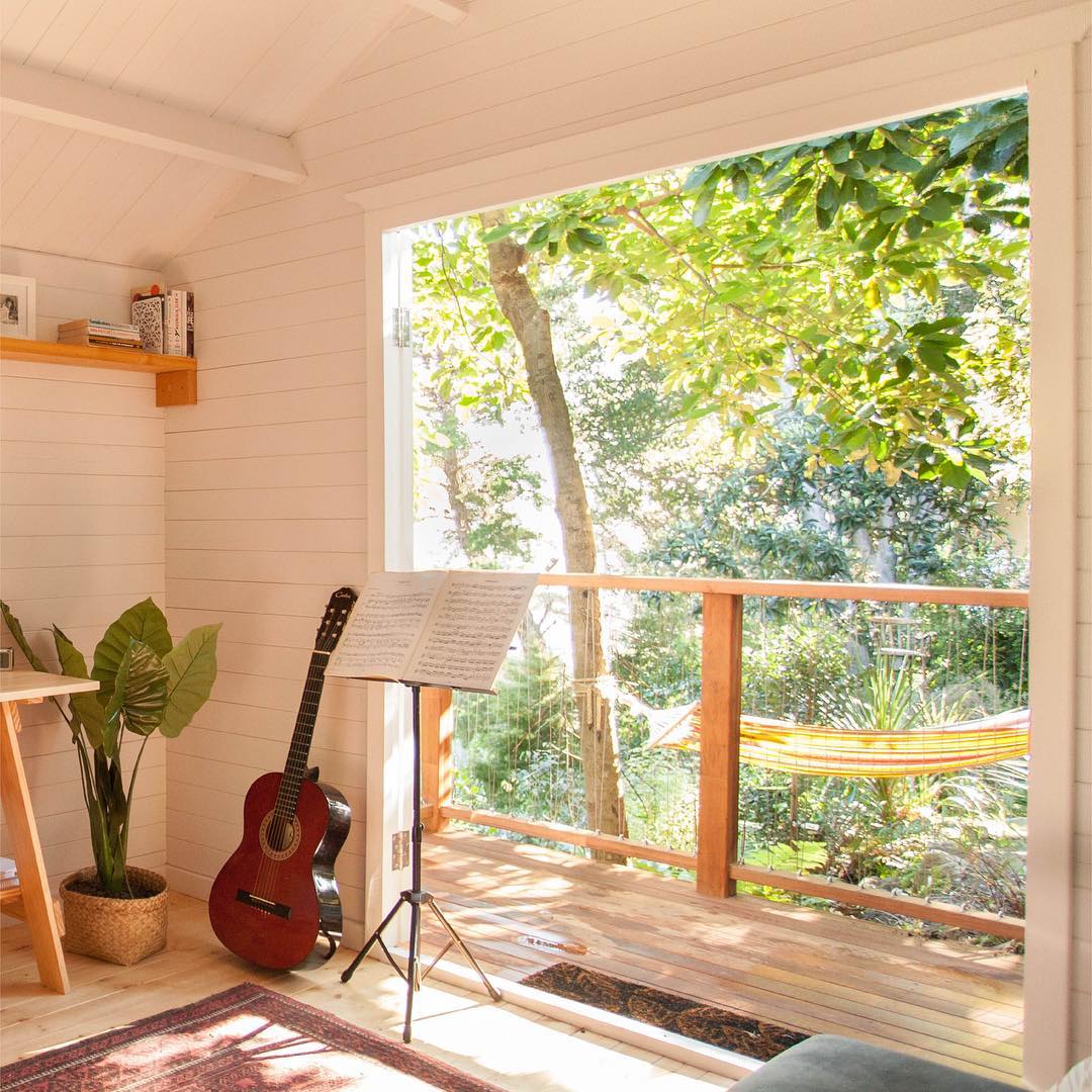 Backyard She Shed with Open Doors and Musical Instruments. Photo by Instagram user @homelandz_decor