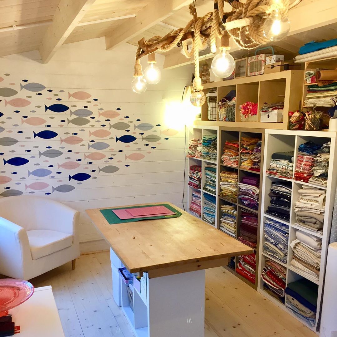 She Shed Set Up as a Craft Room with Workbench In the Middle. Photo by Instagram user @theseasidesew