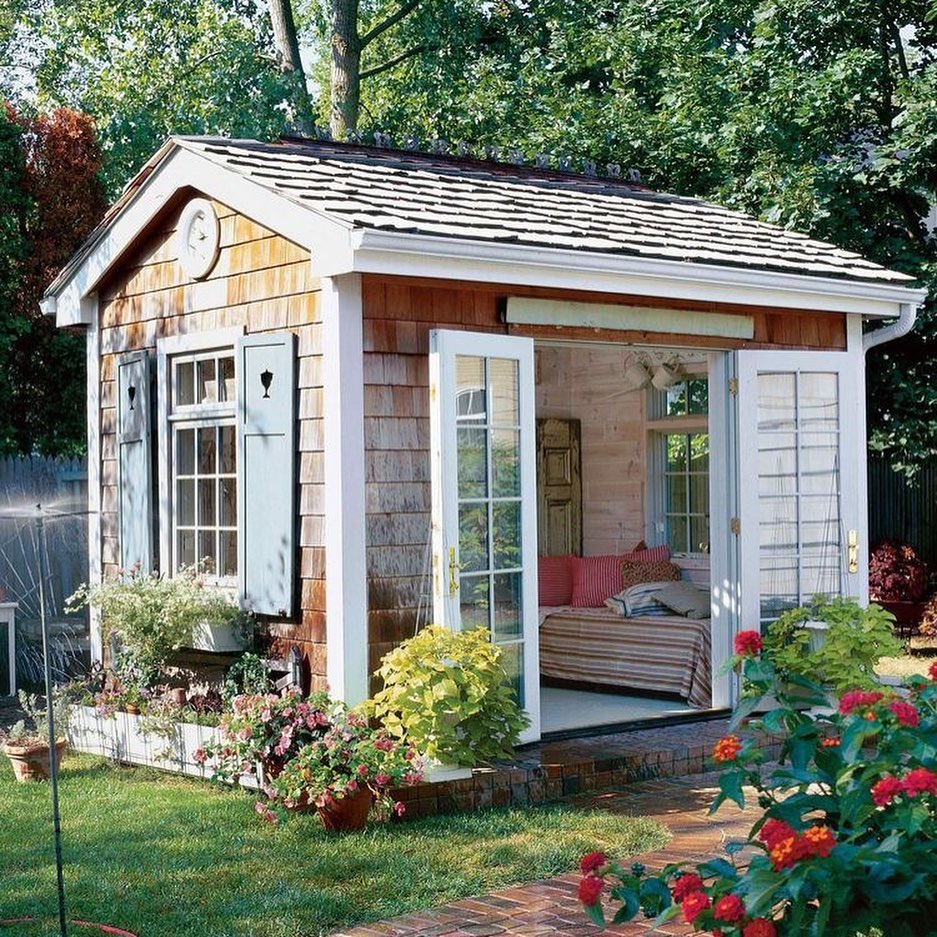 Backyard She Shed with Doors Open and a Small Bed Inside. Photo by Instagram user @sarahellensellschs