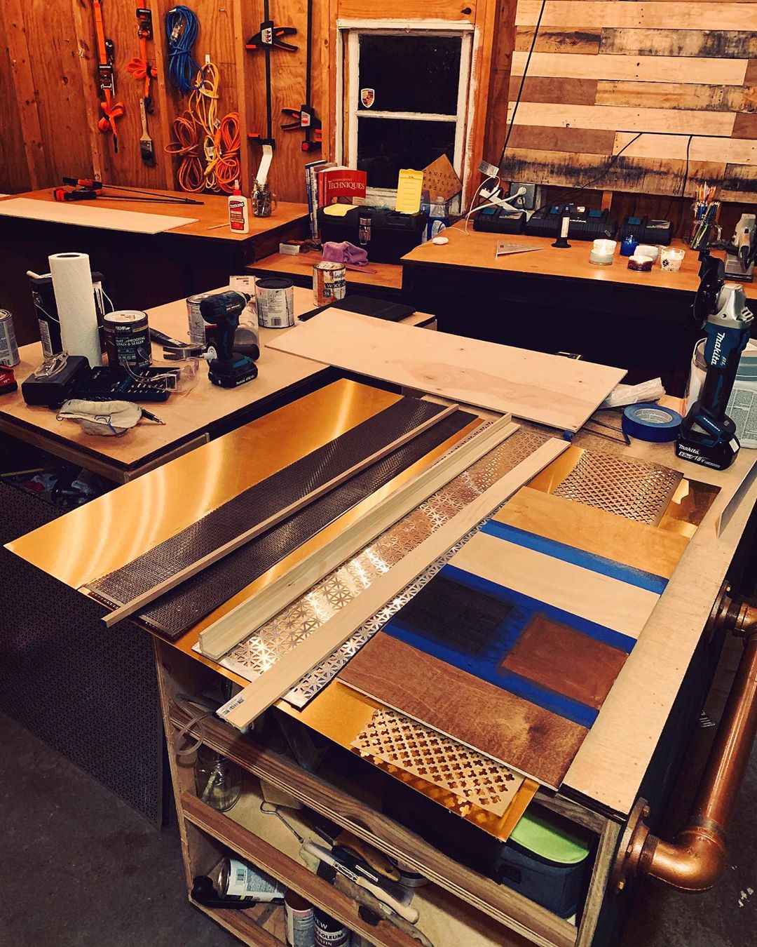 Wood Shop She Shed with Work Table Covered in Pieces of Wood. Photo by Instagram user @roirenovations