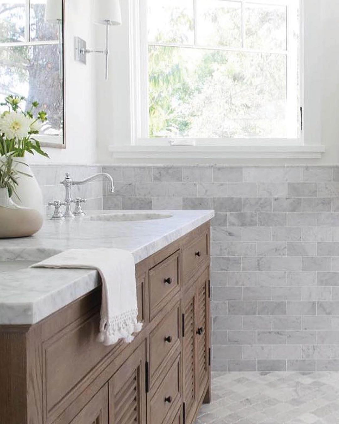 Updated Bathroom with Classic Backsplash. Photo by Instagram user @bedrosianstile