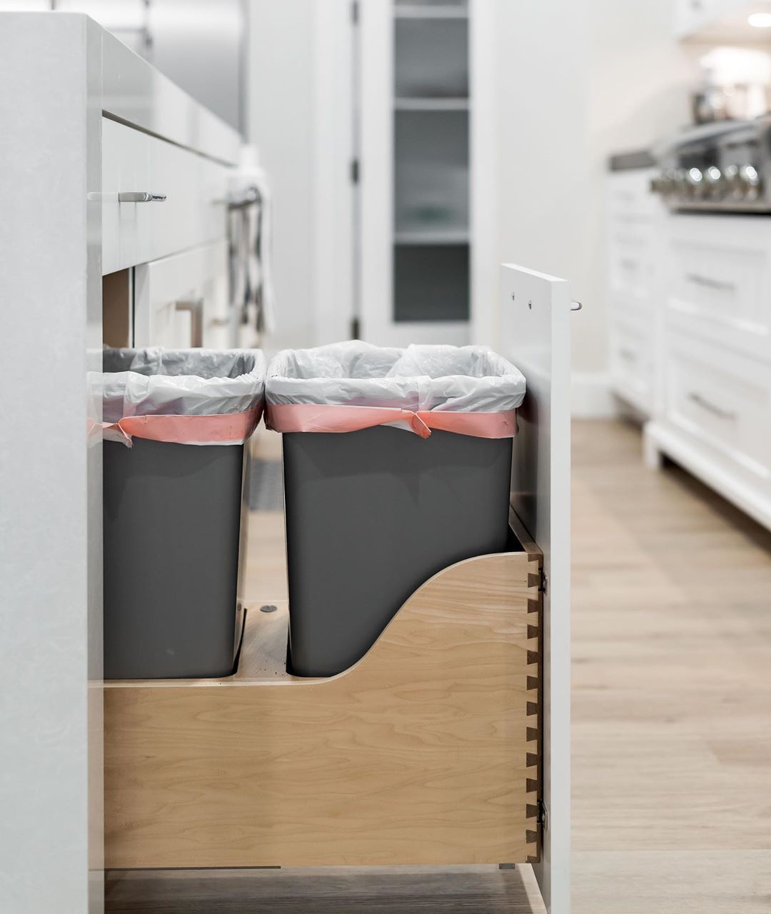 Trash Compartment Installed In a Kitchen Island. Photo by Instagram user @thecabinetgalleryutah