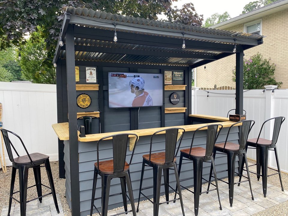 Backyard Bar Area with TV and Large Barstools. Photo by Instagram user @taverns_to_go