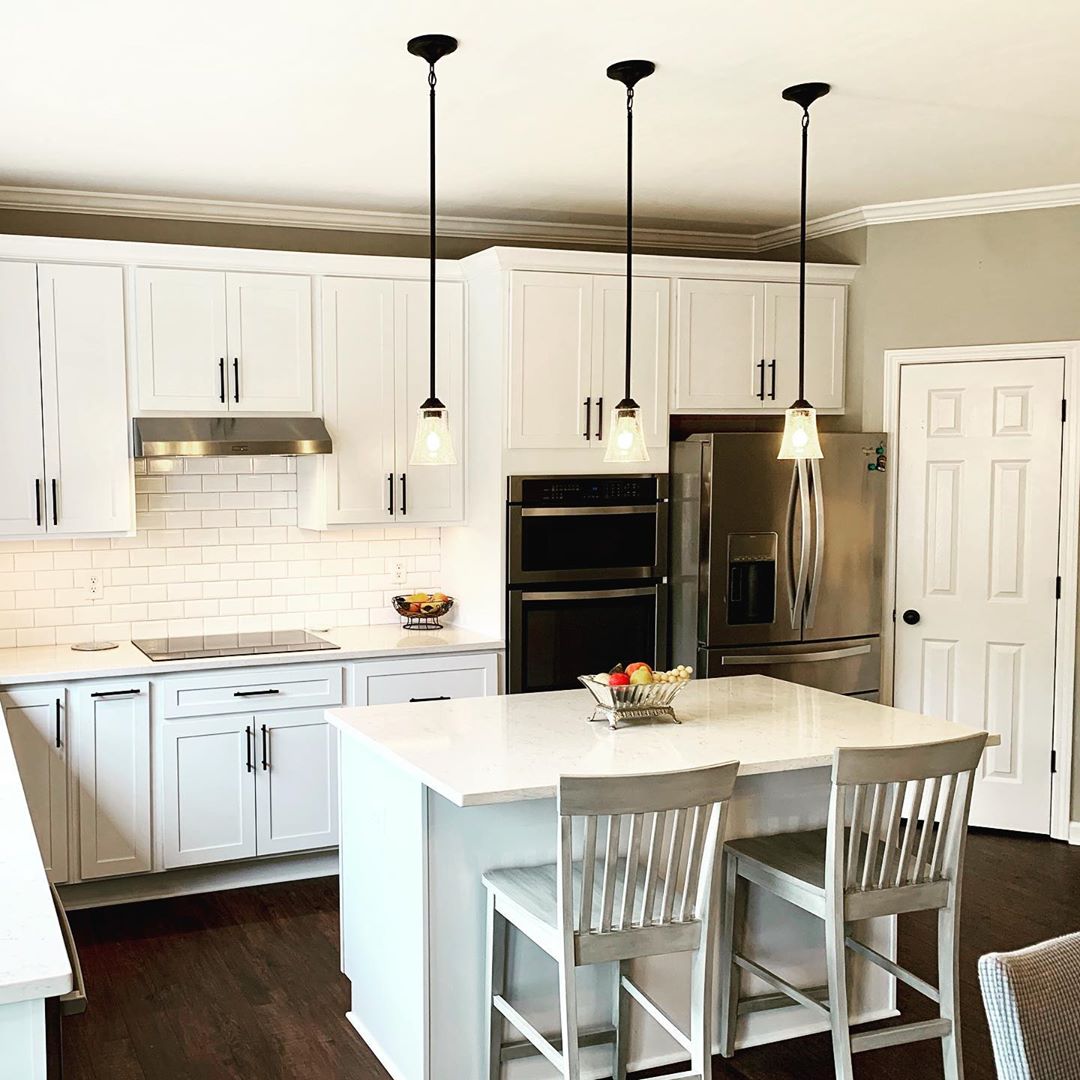 Updated Kitchen Cabinets Painted White with Black Hardware. Photo by Instagram user @boyleshomeimprovementinc