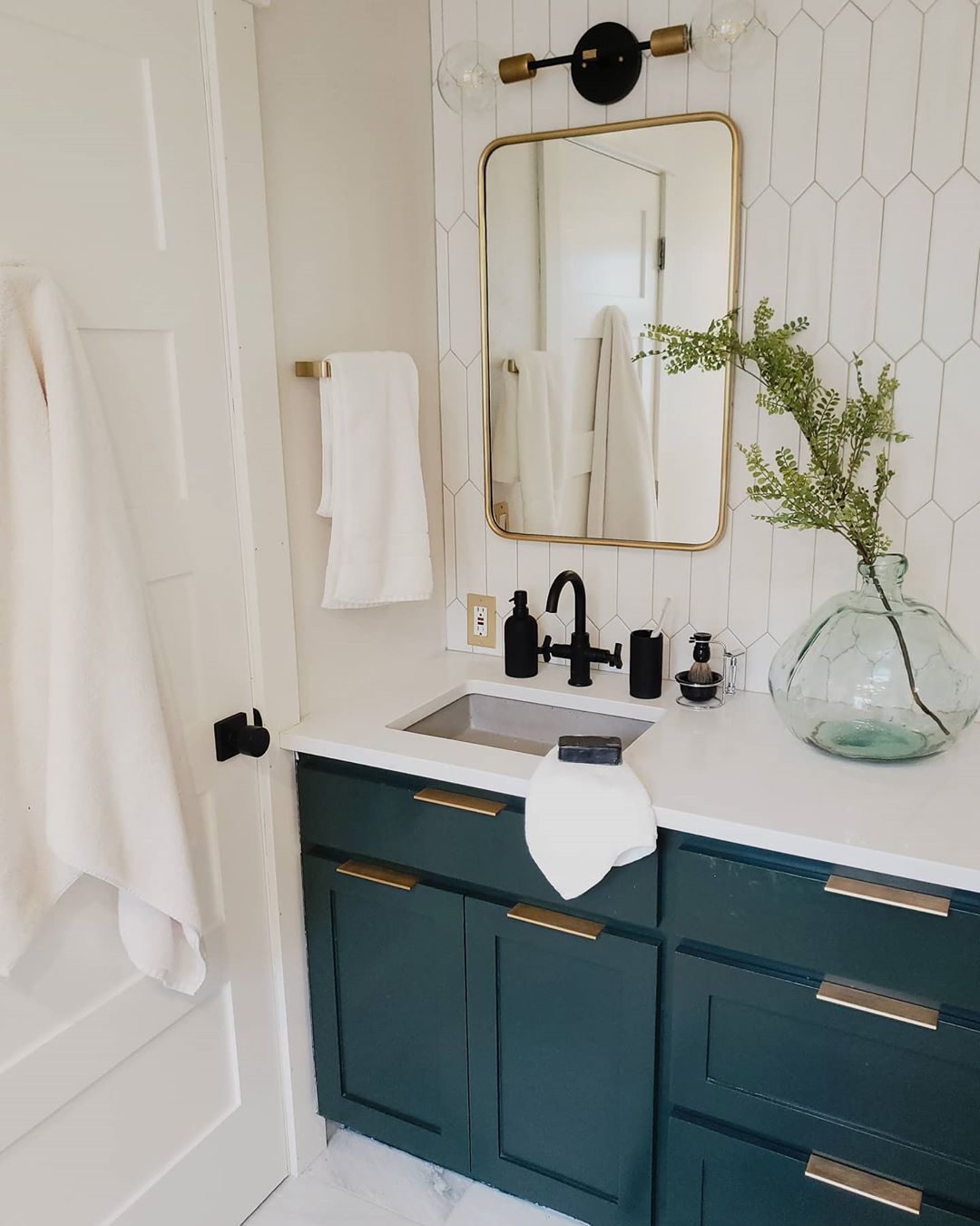 Updated Bathroom with Blue Painted Cabinets with Gold Hardware. Photo by Instagram user @craven_haven