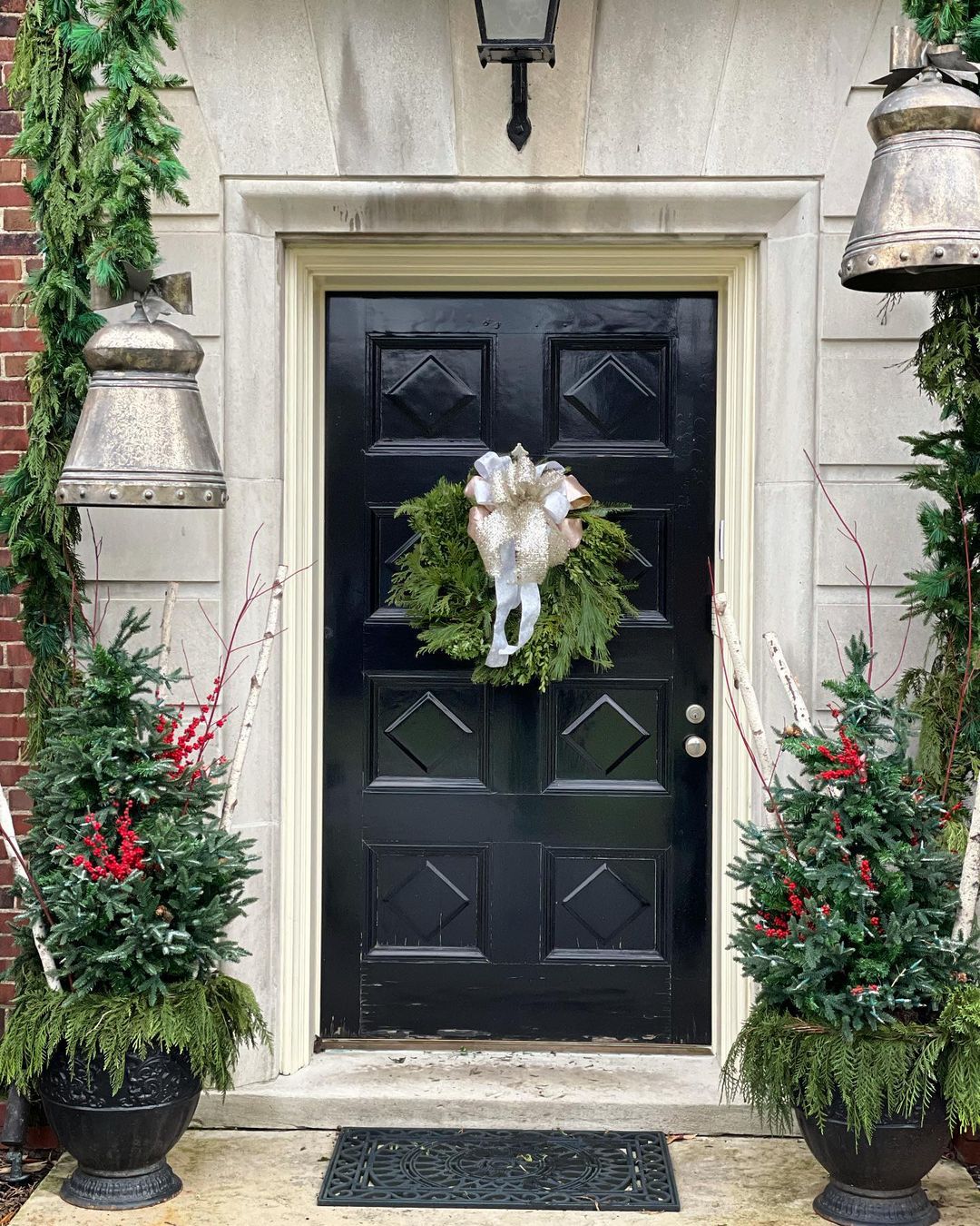 iron door with garland and bells. Photo via @fox.andthefleur