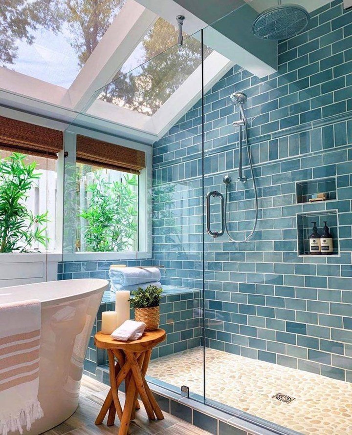 Blue bathroom with skylight. Photo by Instagram user @schultzrealty