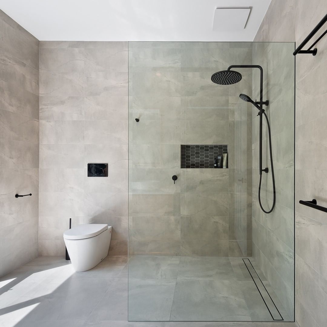 Gray modern tile shower with ventilation fan. Photo by Instagram user @fantechtrade