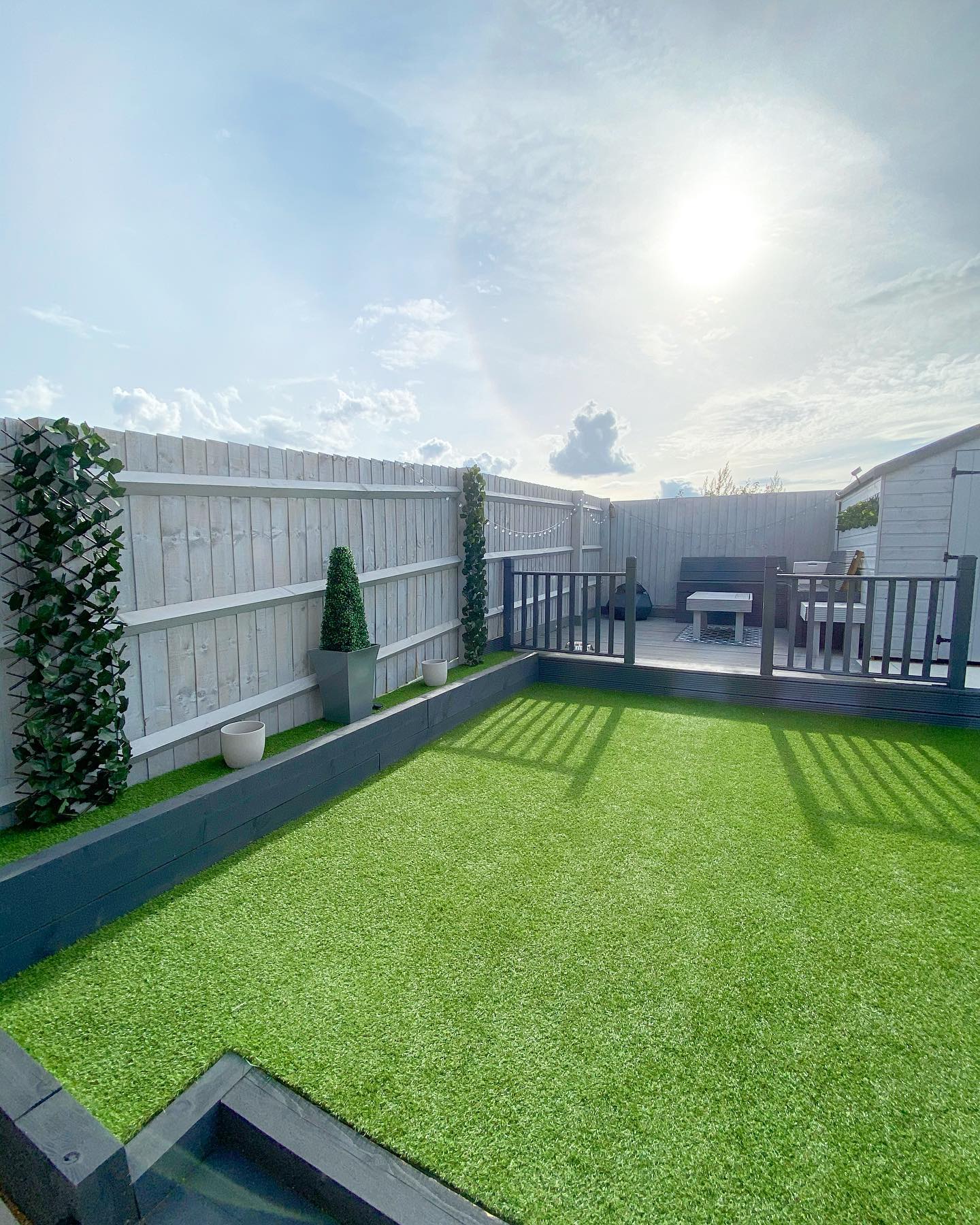 A green lawn in fenced backyard. Photo by Instagram user @littlerenohouse