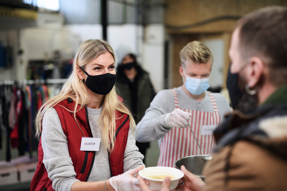 Volunteer wearing mask serving food