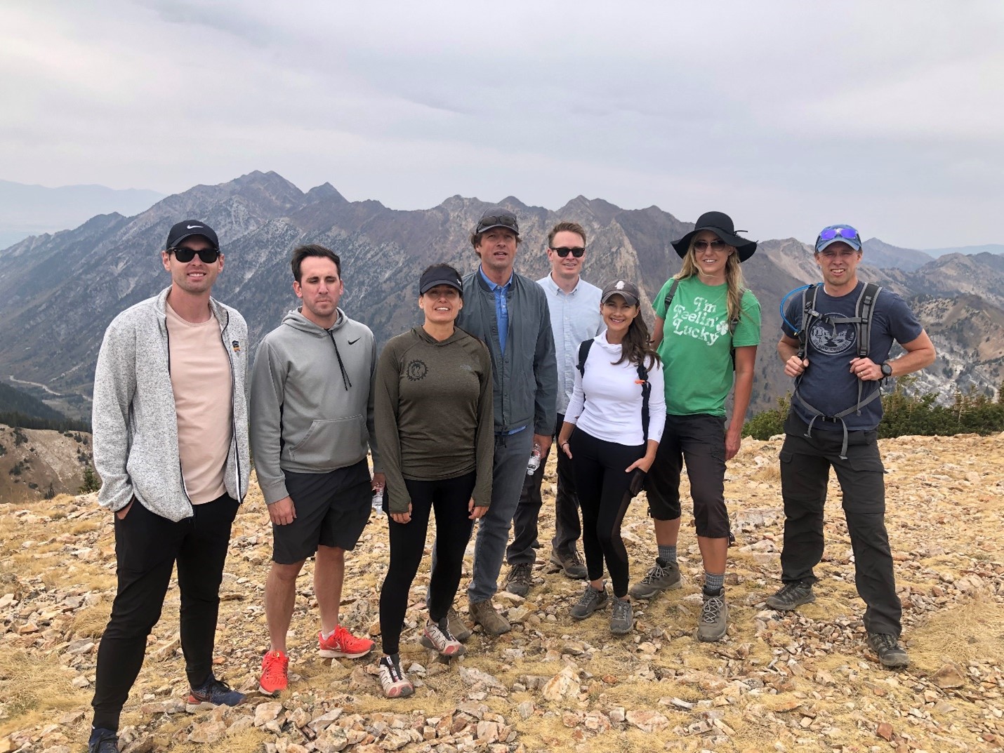Extra Space Storage Investments Team Standing Atop a Hill Hiking Together