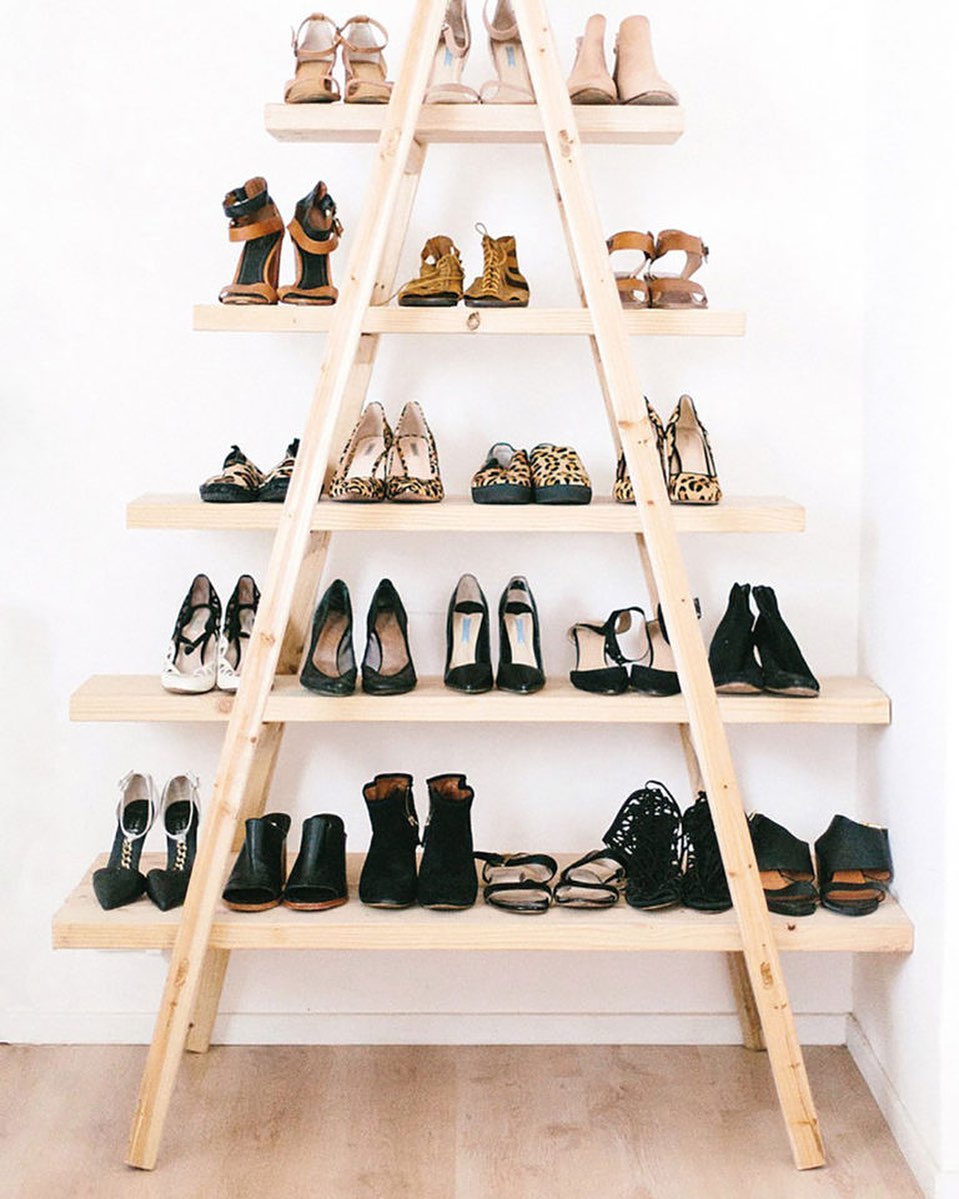 Wood ladder being used for shoe storage.