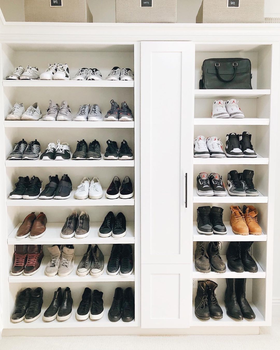 Shoes stored on open shelves in a closet.