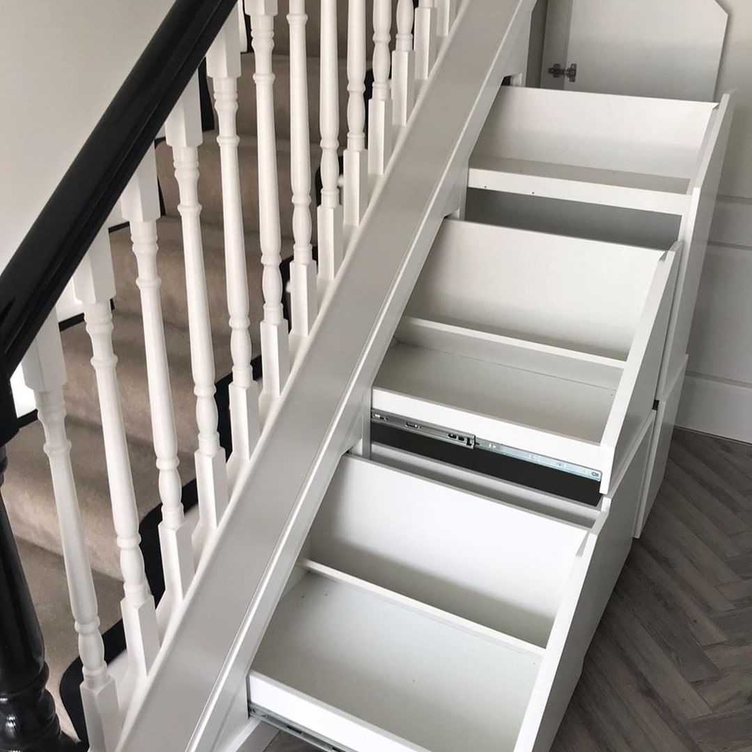 Empty drawers that pull out from underneath the stairs.