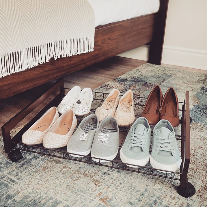 Shoes on gliding shoe rack that fits underneath the bed.