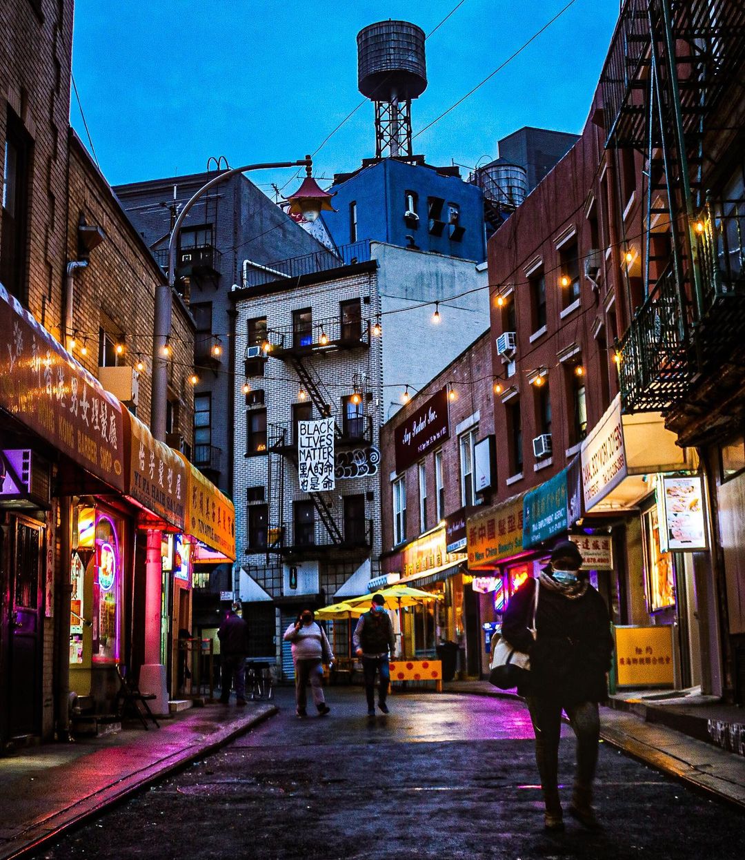 People Walking Through Side Streets in Chinatown in NYC. Photo by Instagram user @katiegodowski_photography