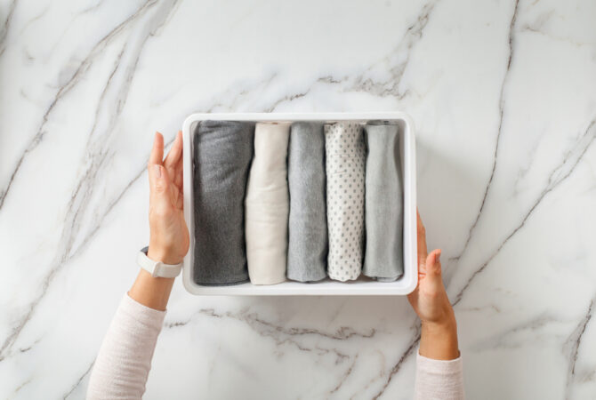 Box with neatly folded garments stacked inside.