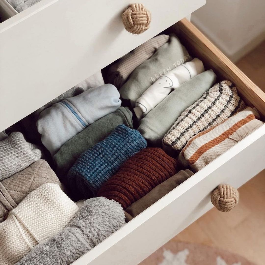 Dresser drawer open to show clothes folded in a file pattern. Photo by Instagram user @thedesignimpact.