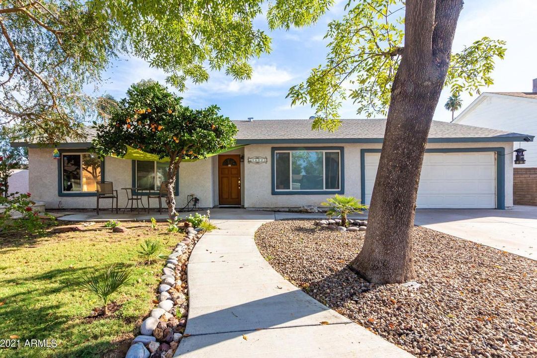 Exterior of gray Ranch home with black trim in Phoenix, AZ