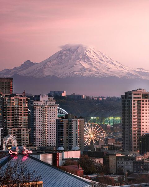 A distant shot of downtown Seattle with Mount Rainier looming in the background. Photo by Instagram user @raymondstiehl.