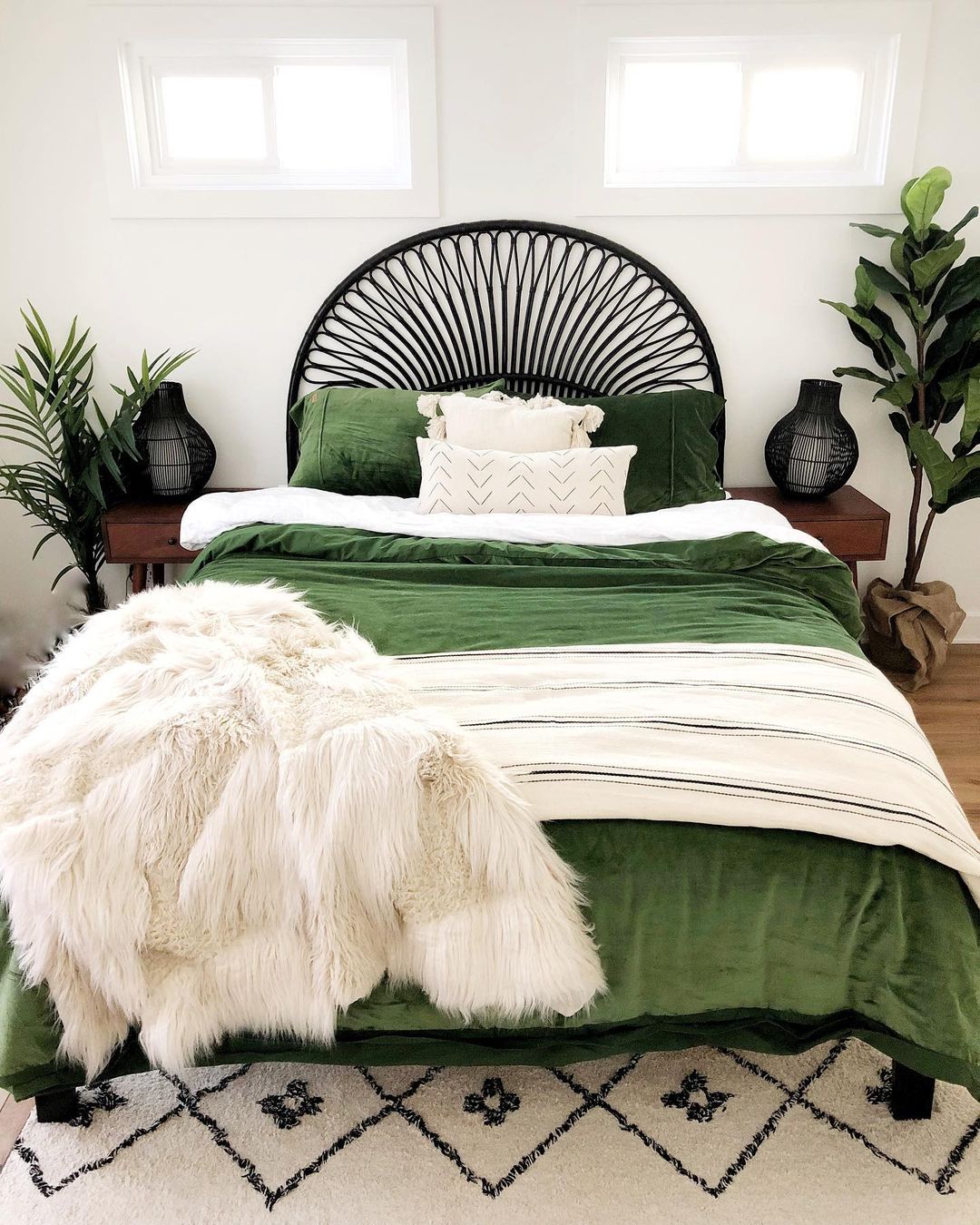 Bed with green bedding and white faux fur blanket. Photo by Instagram User @cottageandsea