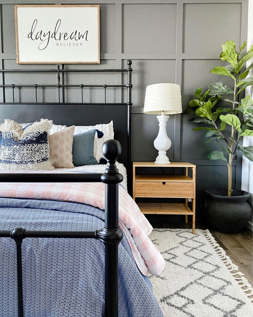 Simple wooden nightstand next to bed. Photo by Instagram User @greybirchdesigns