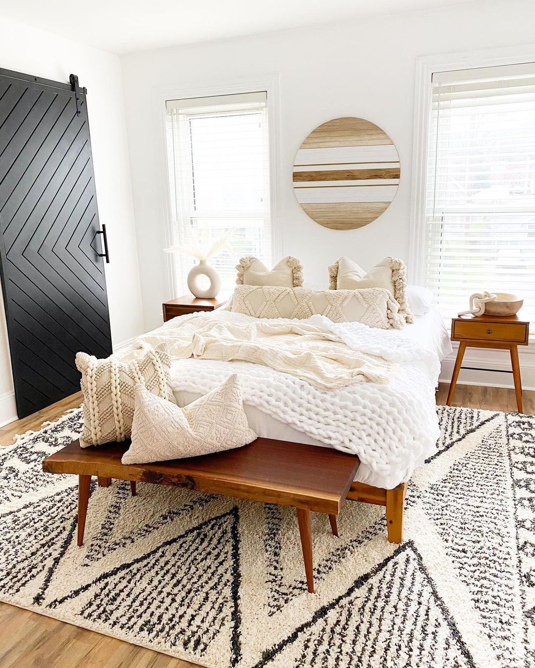 Bright boho bedroom with black and white patterned rug. Photo by Instagram User @modernly_you