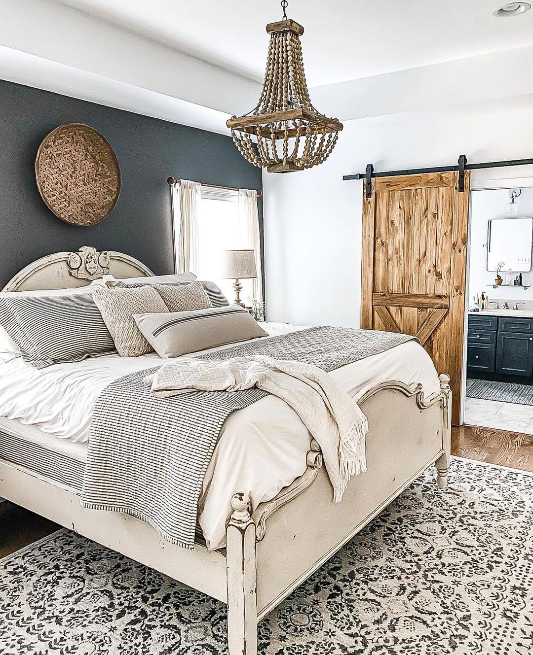 Farmhouse style vintage bed with weathered white paint finish. Photo by Instagram User @alittledoseofjen