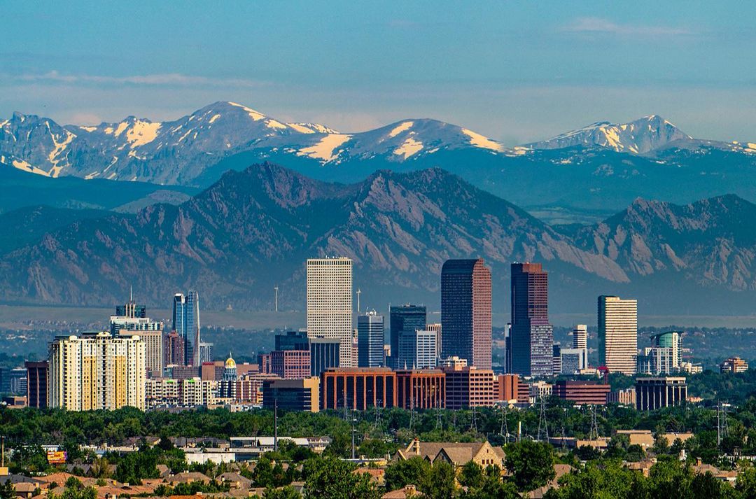 Shot of downtown Denver, CO with Rocky Mountains in the background. Photo by Instagram user @sam_kilman