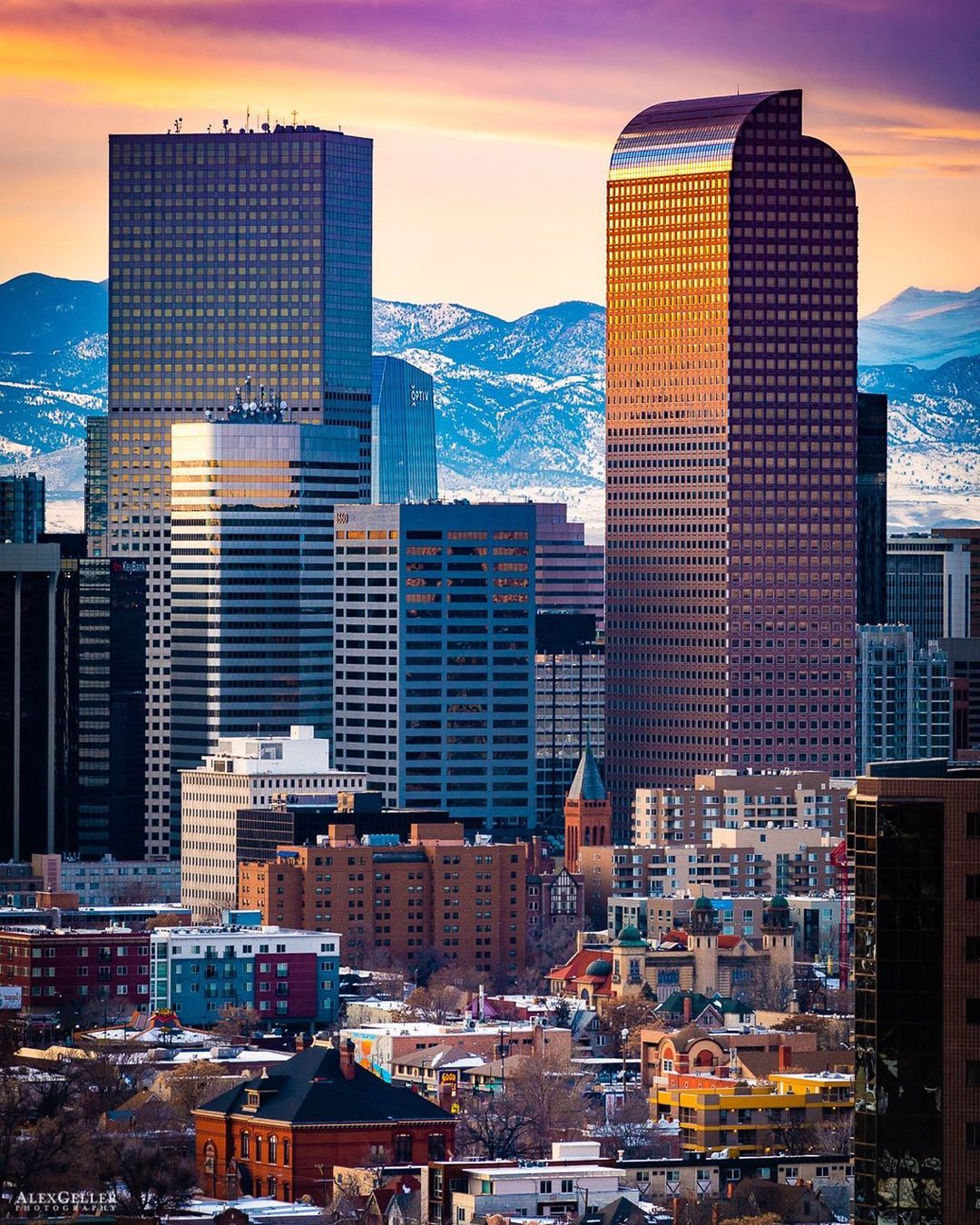 View of Downtown Denver, CO Skyline with Rocky Mountains in the Background. Photo by Instagram user @agellerphoto