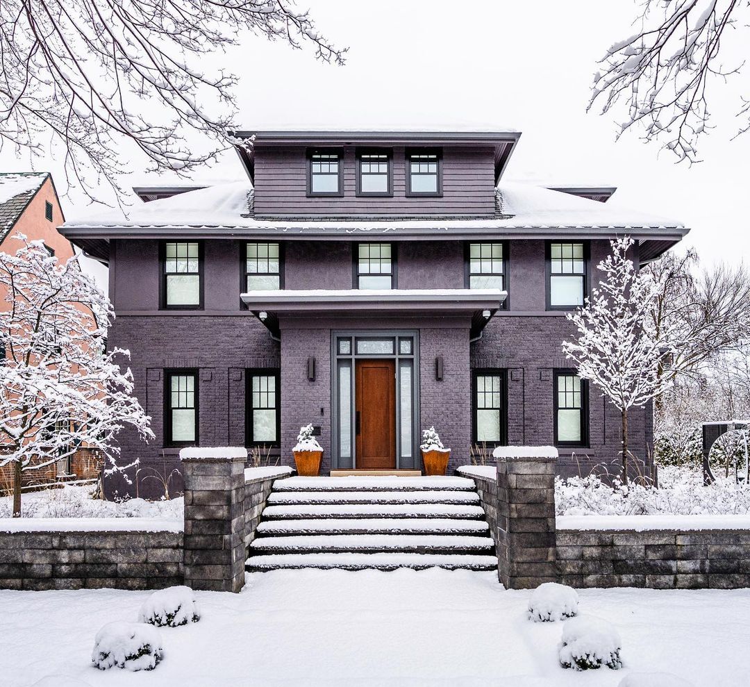 Dark brick home covered in snow in Buffalo, New York. Photo by Instagram user @buffalohomes