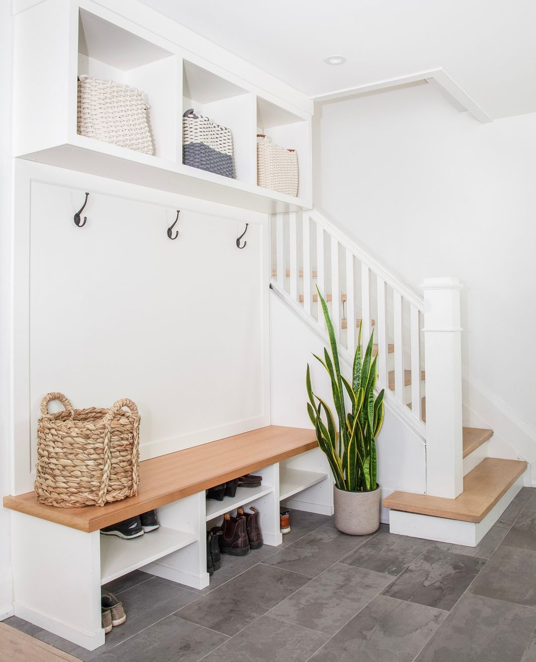 Cleaned Up Minimalist Mud Room with Floor and Overhead Storage. Photo by Instagram by @studio8designinc