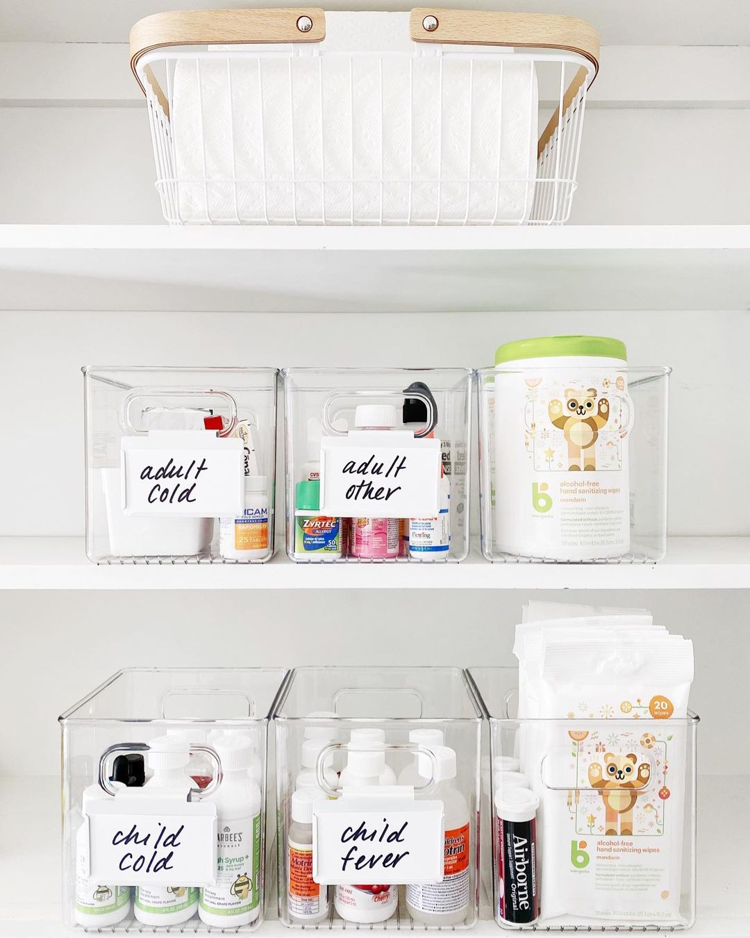 Medicine cabinet that's organized using clear plastic bins. Photo by Instagram user @breathing.room.organization